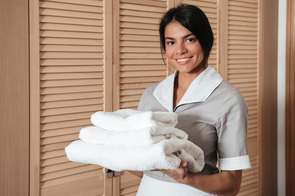 reliable maid holding fresh clean folded towels