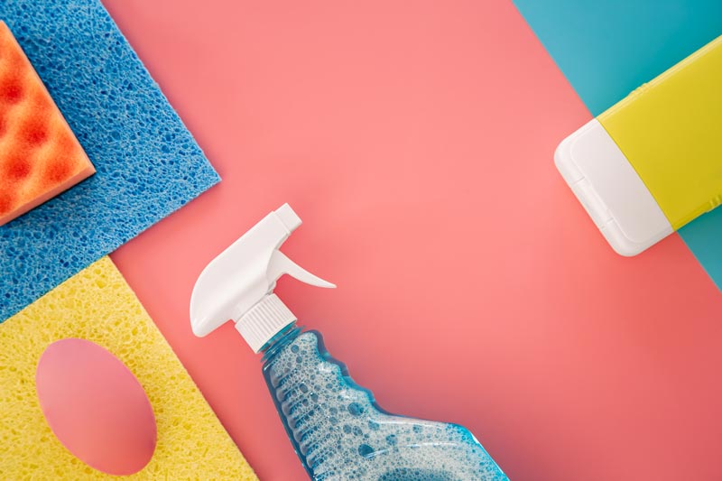 house cleaning products on pink background